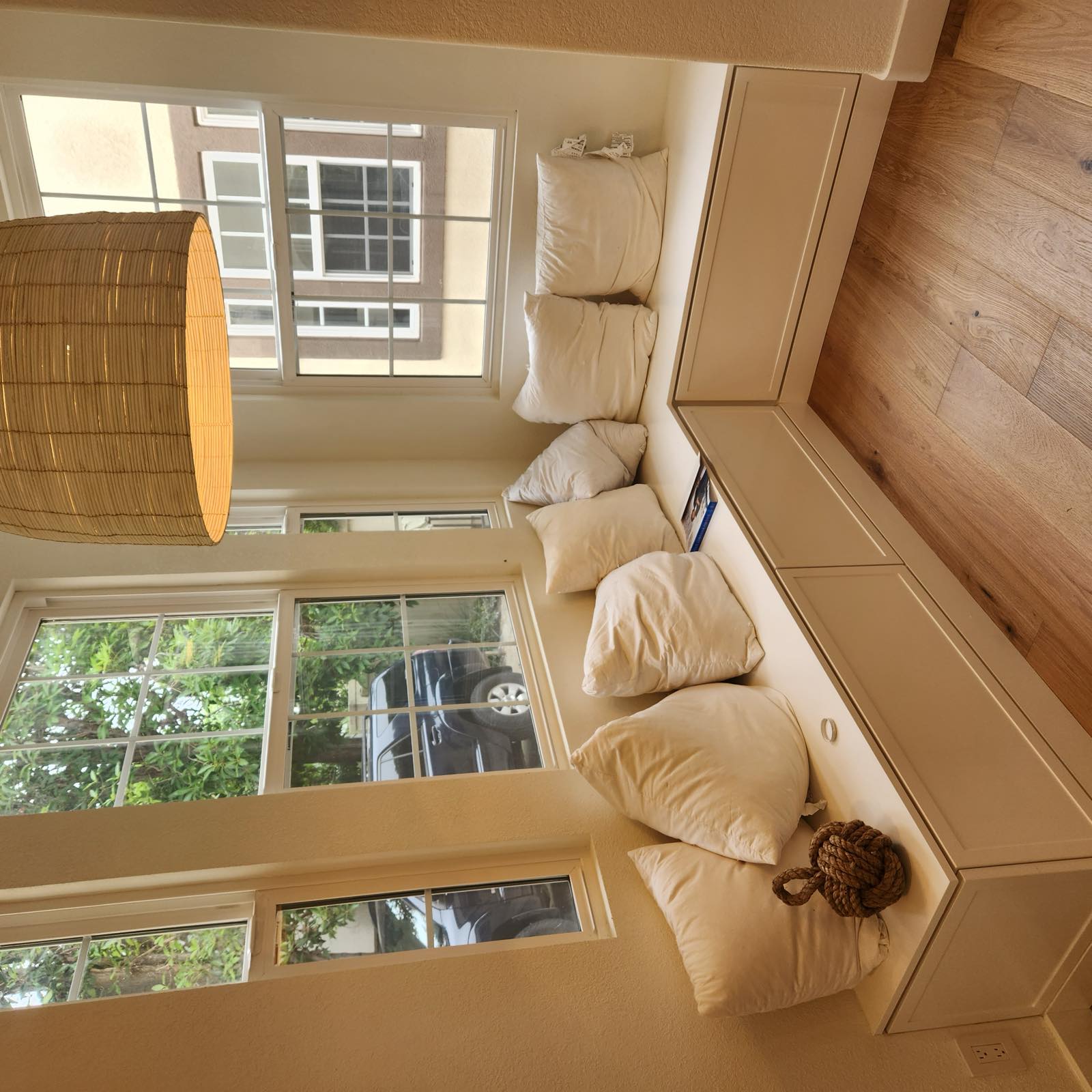 Custom built-in window seat banquette with drawer storage in a corner breakfast nook
